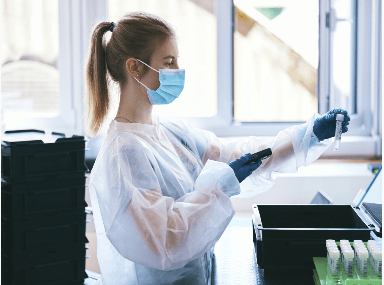 ender diagnostics lab technician handling a saliva sample tube